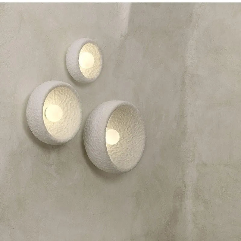 Japanese-style modern wall lamp with white resin shade in three size options.