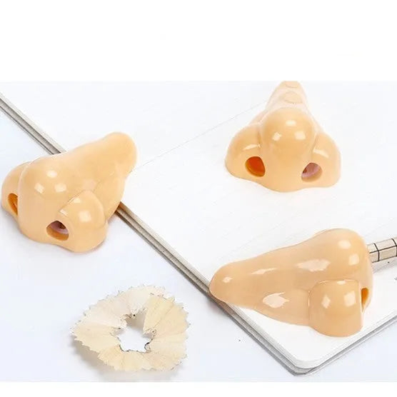 Flesh colour plastic pencil sharpener with large nostril design measuring 58x45x30mm
