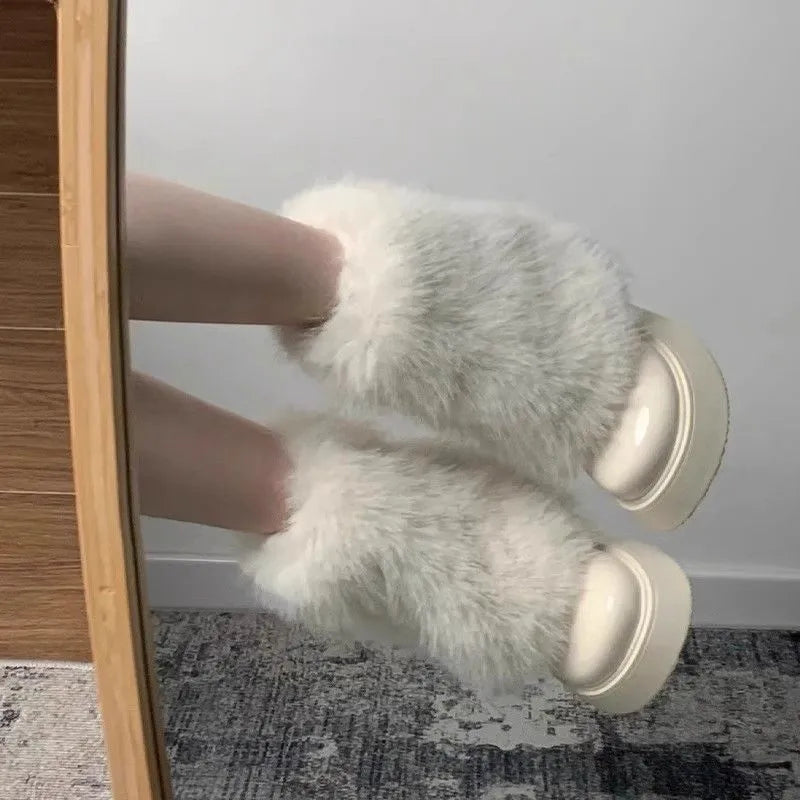 Women's black fleece-lined low-top snow boots with a waterproof rubber platform sole on a white background.