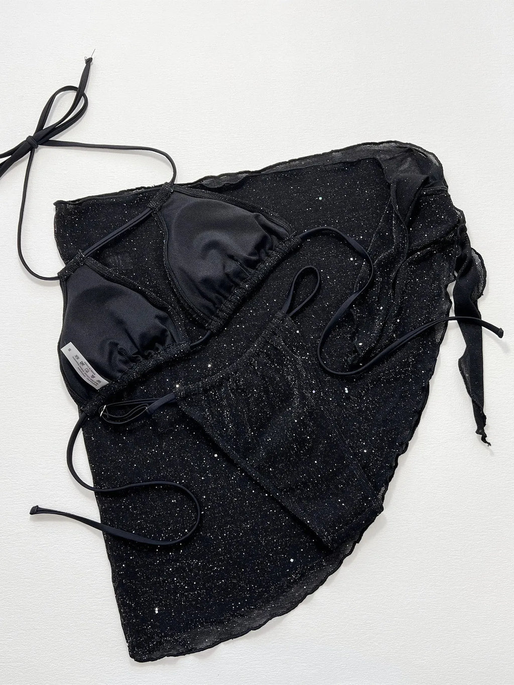 Black women's three-piece bikini swimsuit set with halterneck top and shorts on a mannequin.
