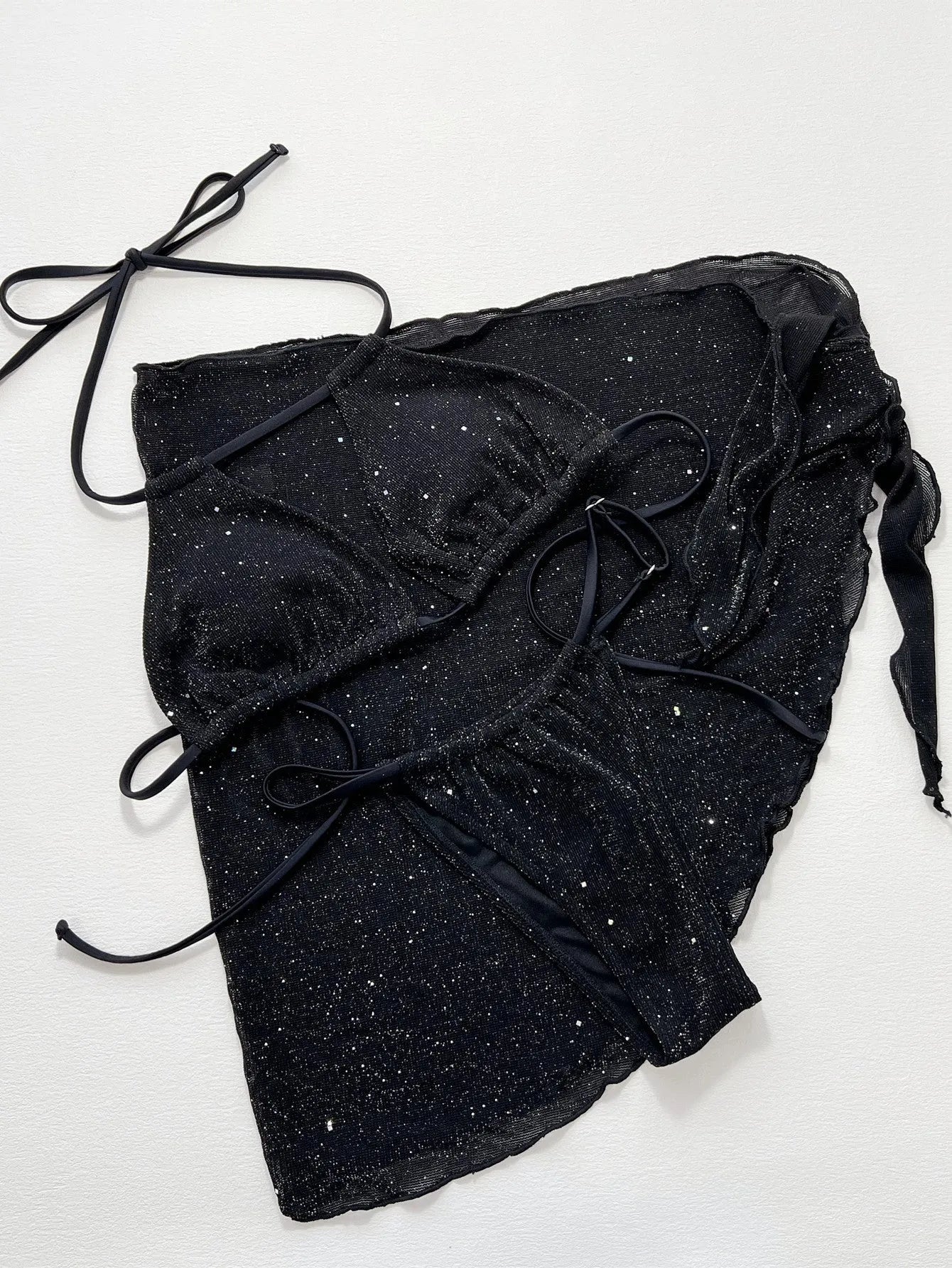 Black women's three-piece bikini swimsuit set with halterneck top and shorts on a mannequin.