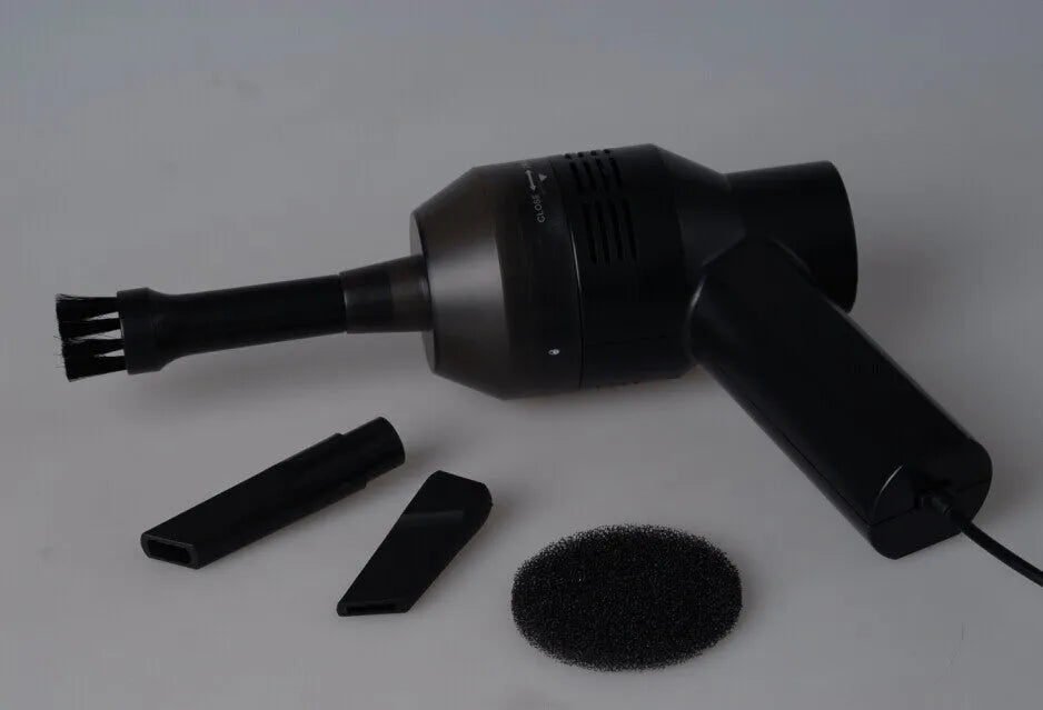 Black desktop mini vacuum cleaner with USB cable and dust collection chamber for keyboard and small space cleaning