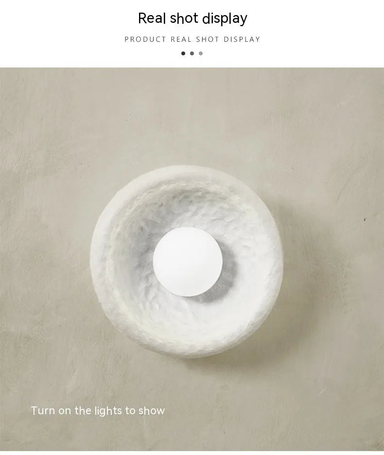 Japanese-style modern wall lamp with white resin shade in three size options.