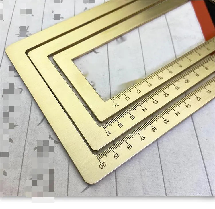 Solid brass calligraphy paper weight with engraved design on a wooden desk.