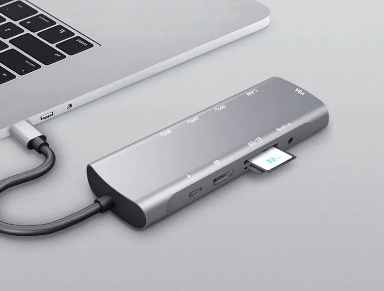 Grey aluminium USB-C docking station with HDMI, VGA, USB 3.0, and USB-C PD charging ports.