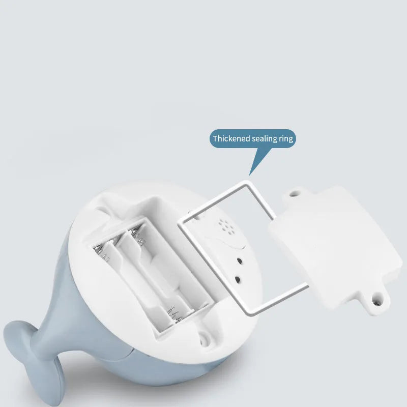 Whale-shaped electric bath toy with water spray, flashing lights, and automatic water sensing feature