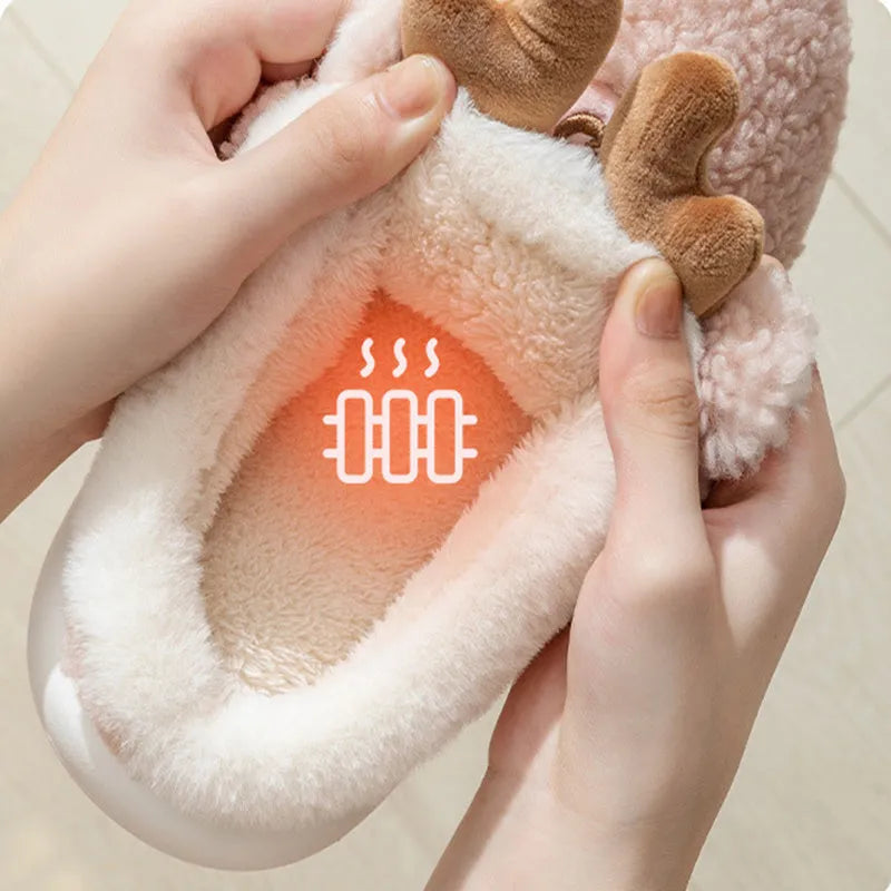Pair of Christmas elk winter home slippers with suede upper and candy-coloured antler print on bedroom floor
