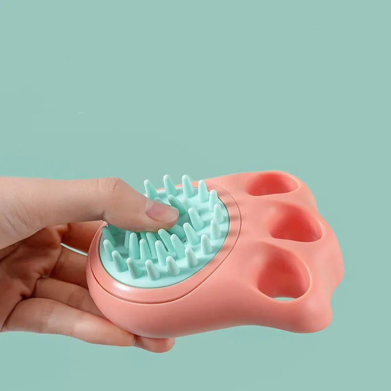 Blue silicone claw pet bath brush for washing cats and dogs on a white background.