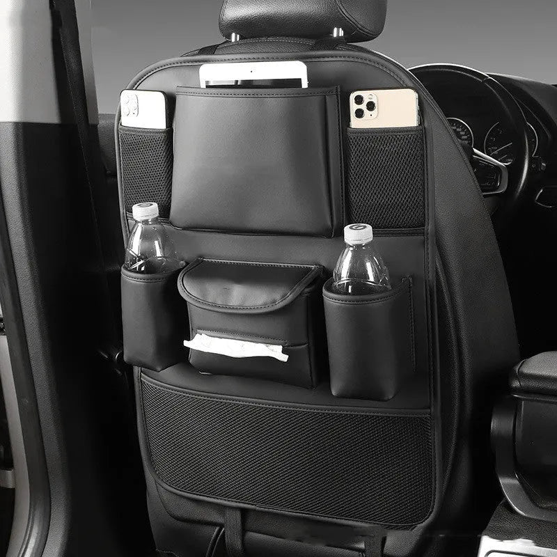Faux leather car seat back storage organiser bag in black, shown hanging behind a car headrest.