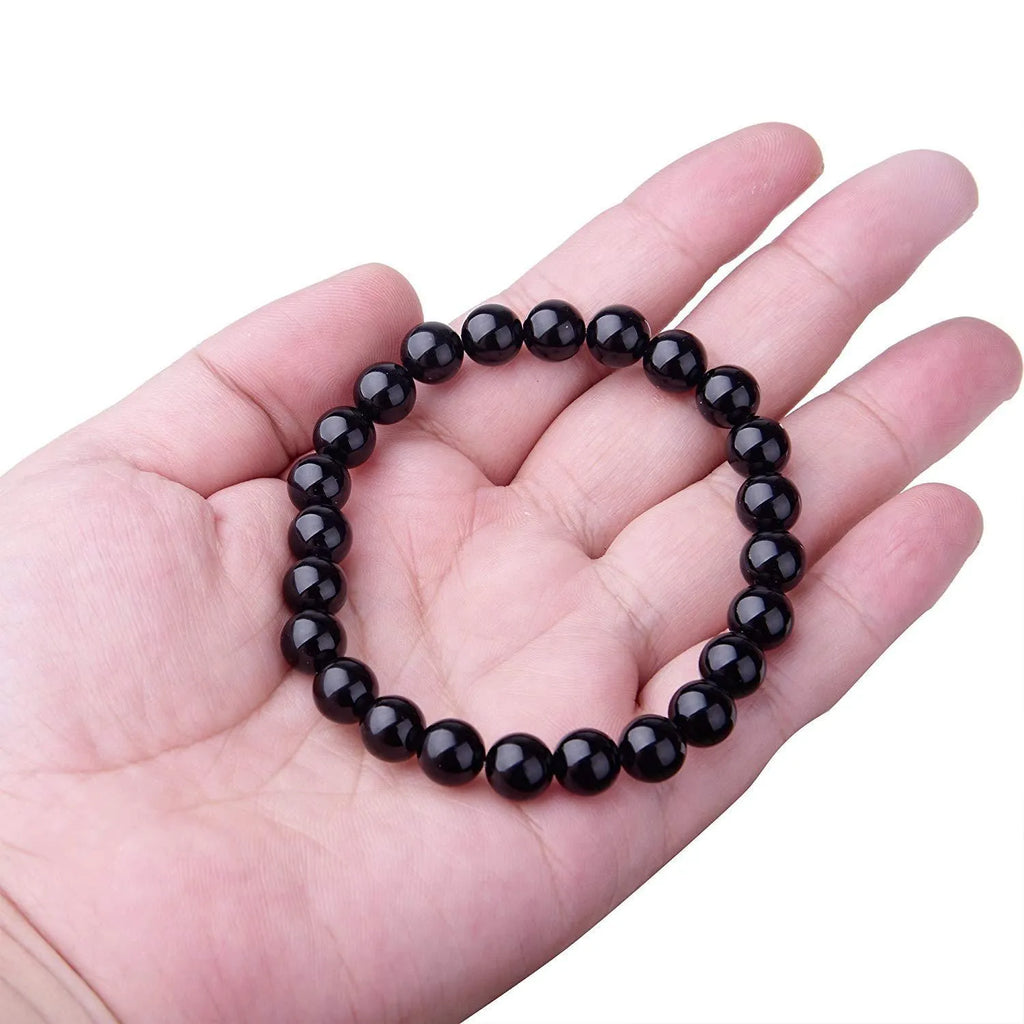 Geometric black agate bead bracelet with elastic cord, showing 8mm bead size detail.