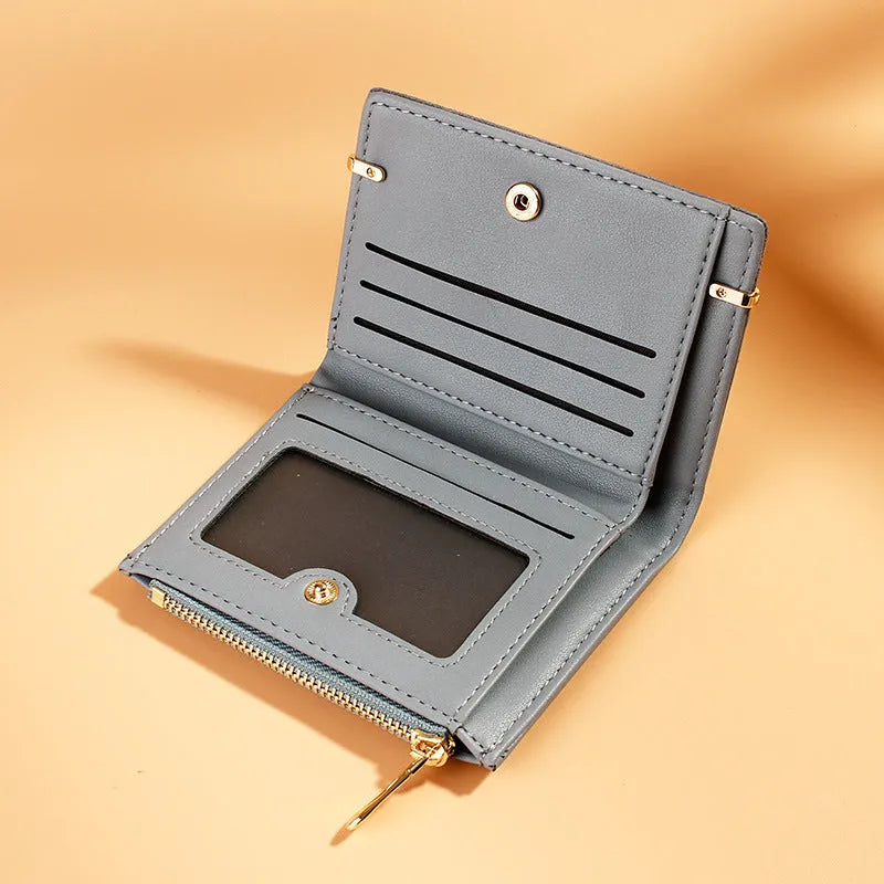 Short black PU leather ladies wallet unfolded to show card slots, coin zipper, bill holder, and hidden compartment.