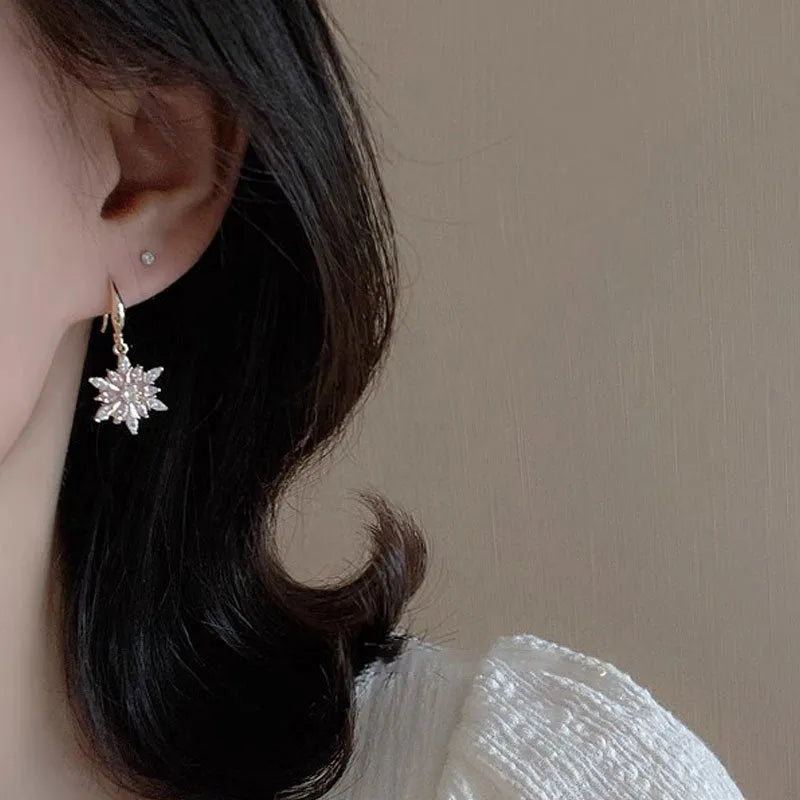 Gold snowflake earrings with zircon stones on alloy base, geometric design for women