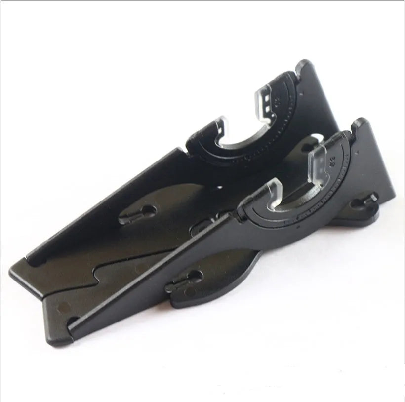 A black plastic card-shaped mobile phone holder with a lazy bracket design on a desktop.
