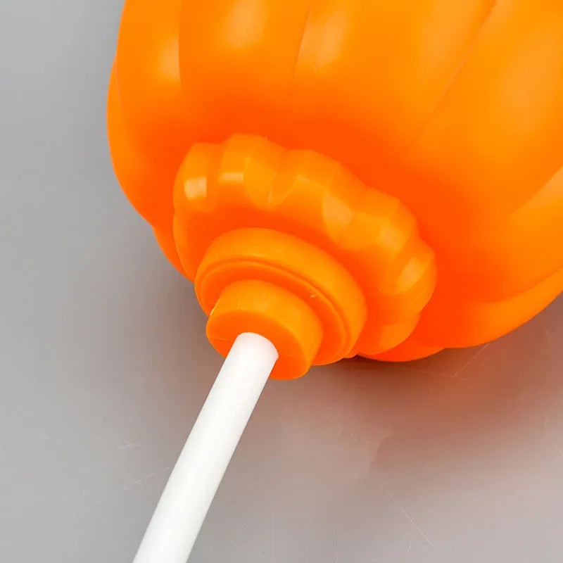 Plastic pumpkin-shaped decorative lamp with USB charging cable, showing purple or yellow light option.