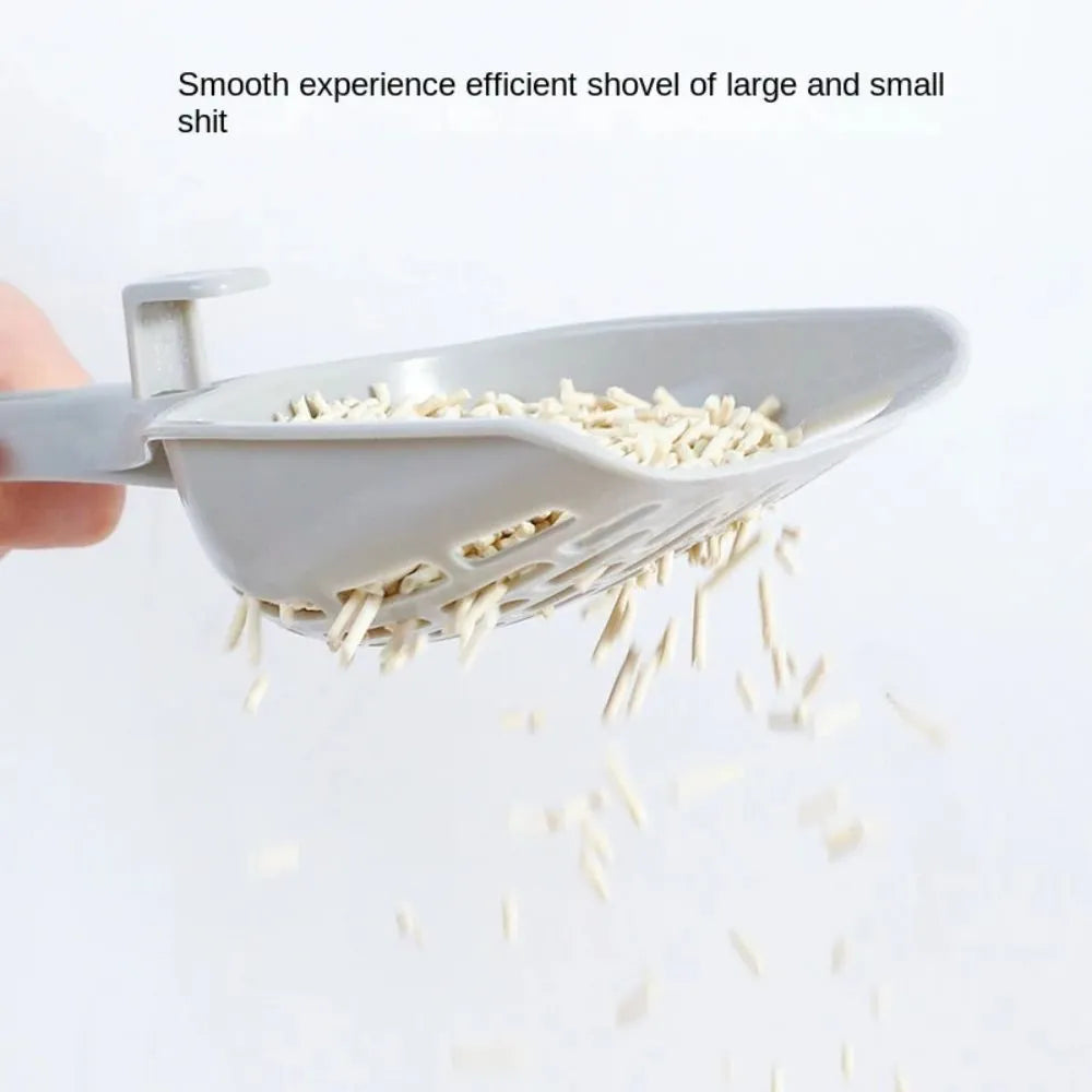 Grey plastic cat litter scoop standing upright in its attached storage base