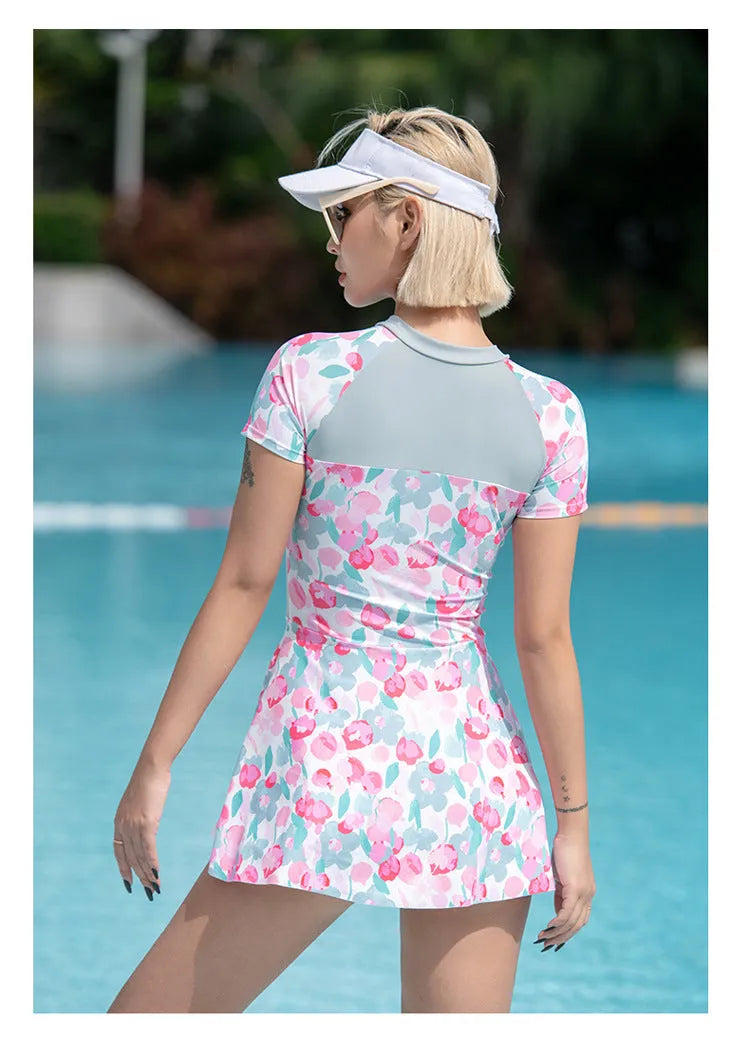 Women's printed plus size one-piece swimsuit on hanger, available in sizes M to 3XL.