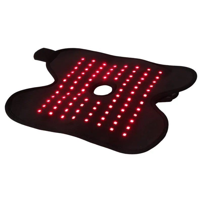 Black fabric ankle support with red light and heating therapy, USB cable, on a flat surface