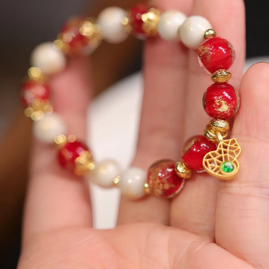 Close-up of a manually crafted gold foil coloured glaze ethnic bracelet for women, showing geometric design.