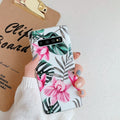 Samsung floral TPU phone case in safflower colour with green leaf design on a table.