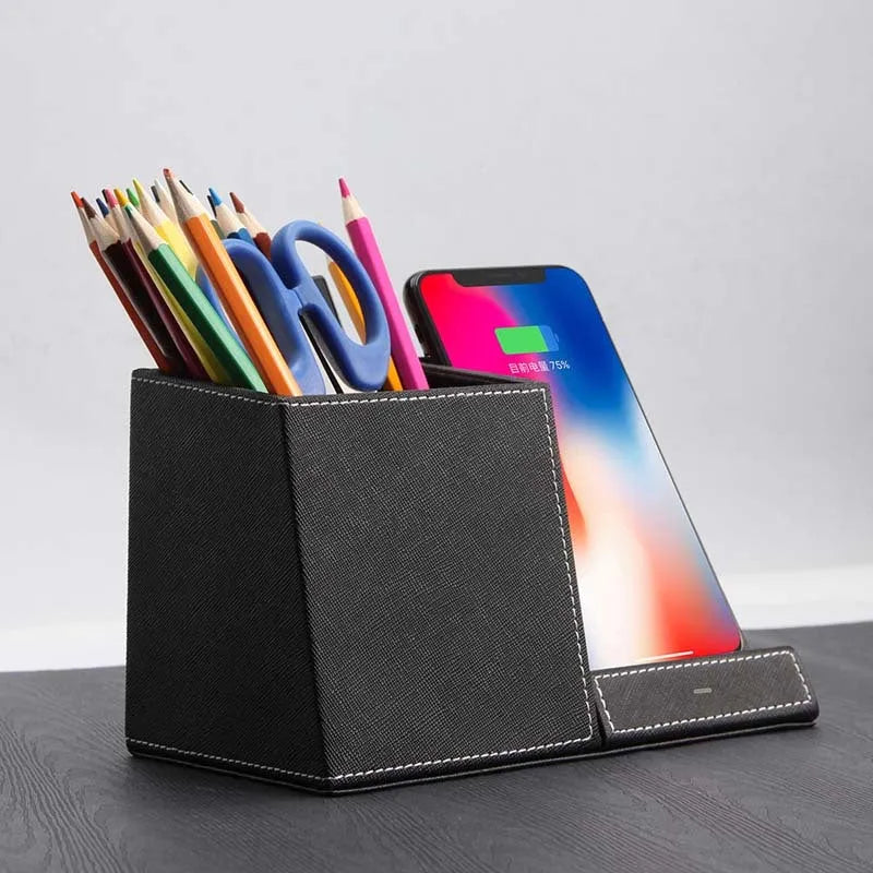 Black leather pen holder with integrated wireless phone charging pad on a desk