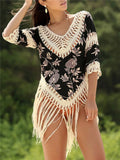 Apricot-coloured women's sun protection blouse with V-neck and hollow-out sleeves on a hanger.