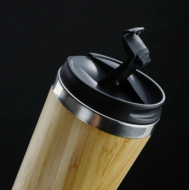 Bamboo and stainless steel insulated coffee cup with lid and foam pad, 420ml capacity.