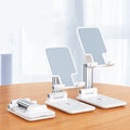 Black and white desktop mobile phone stand with wireless charging capability