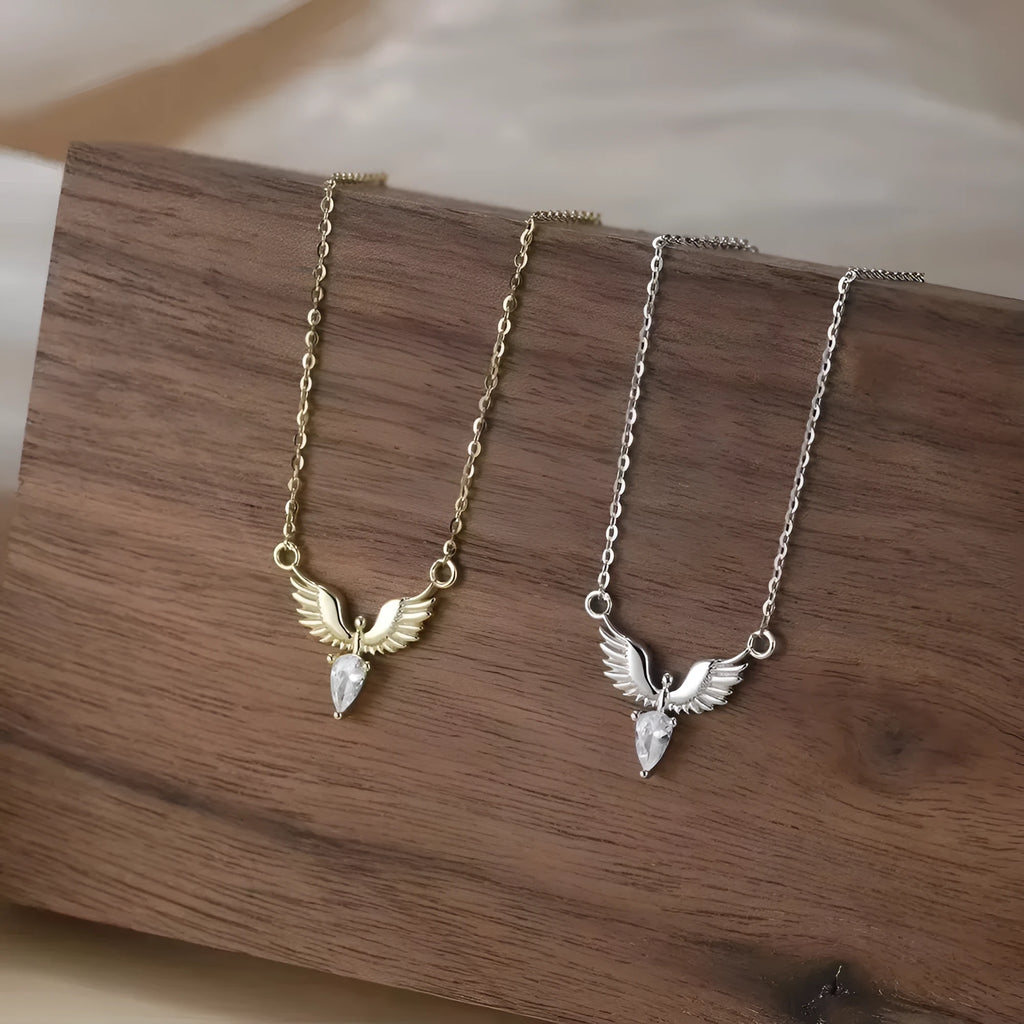 Close-up of a sterling silver eagle pendant necklace on an O-ring chain, showing white gold and yellow gold colour options.