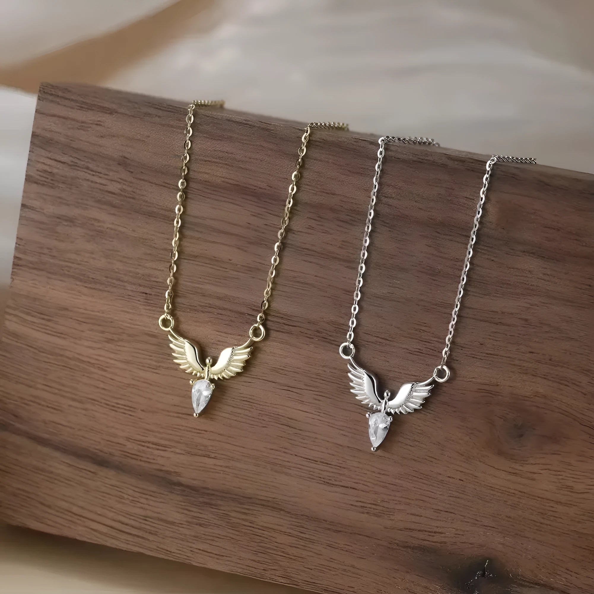 Close-up of a sterling silver eagle pendant necklace on an O-ring chain, showing white gold and yellow gold colour options.