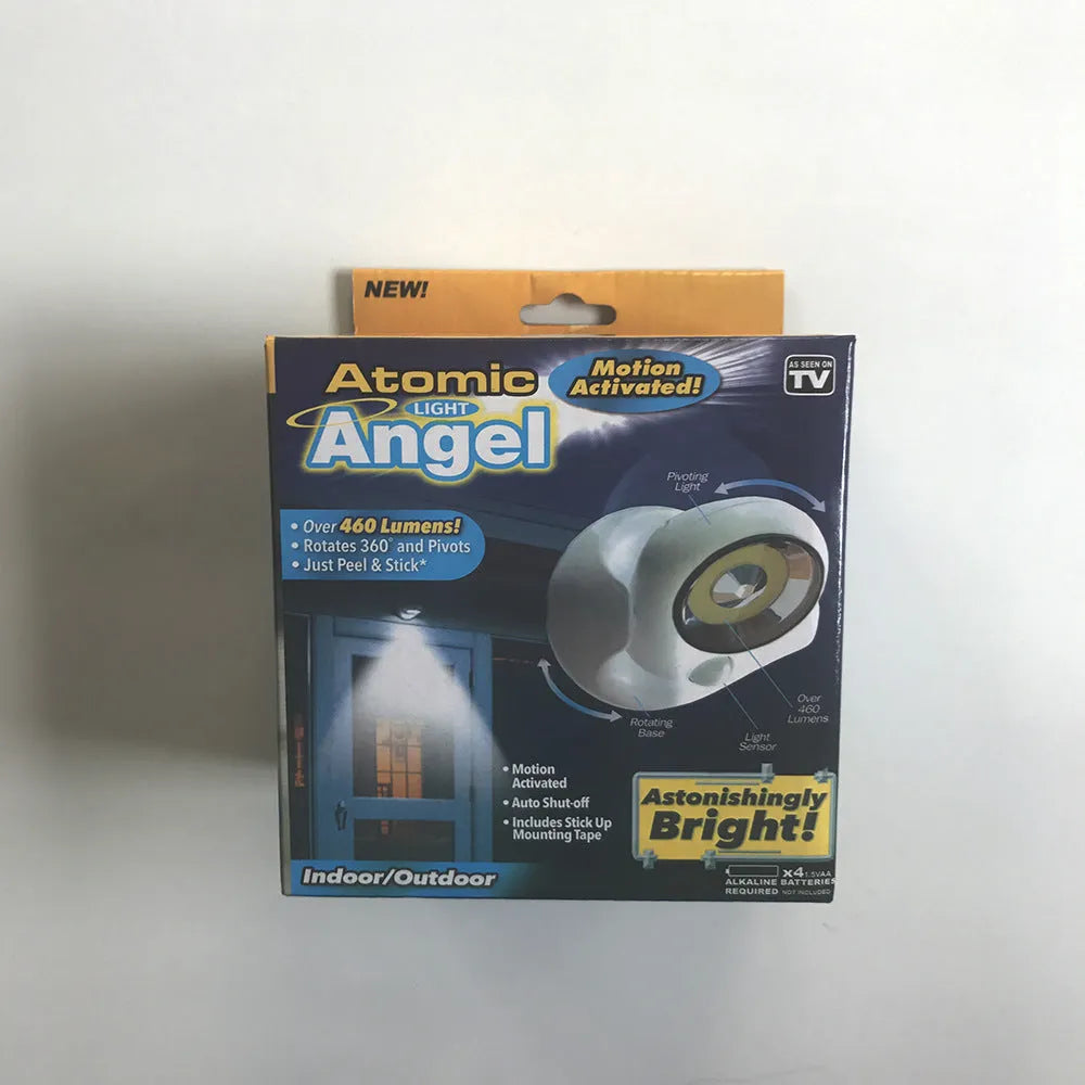 White Atomic Angel shaped induction night light on a surface.