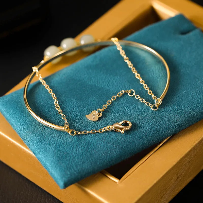 Women's Hetian jade lucky bracelet with gold inlay in single, double, and three bead styles.