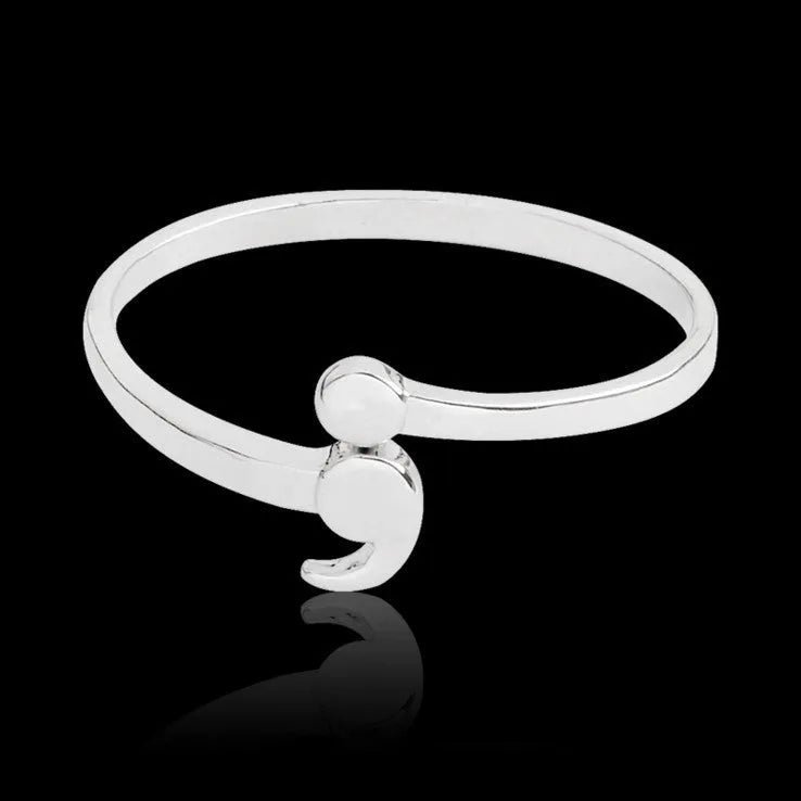 Women's silver-tone alloy ring available in sizes 5 to 10, simple band design