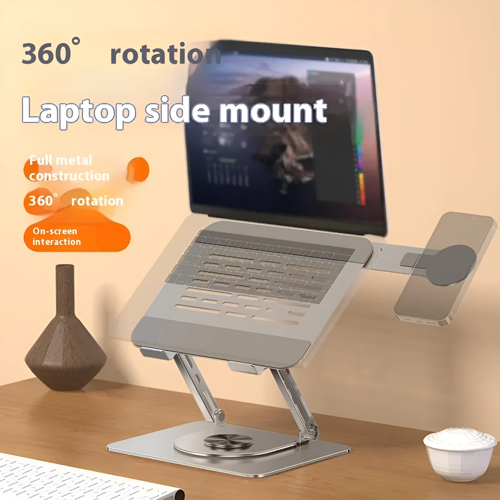 Silver carbon steel laptop stand in rotated position with a magnetic phone holder attached to the side.