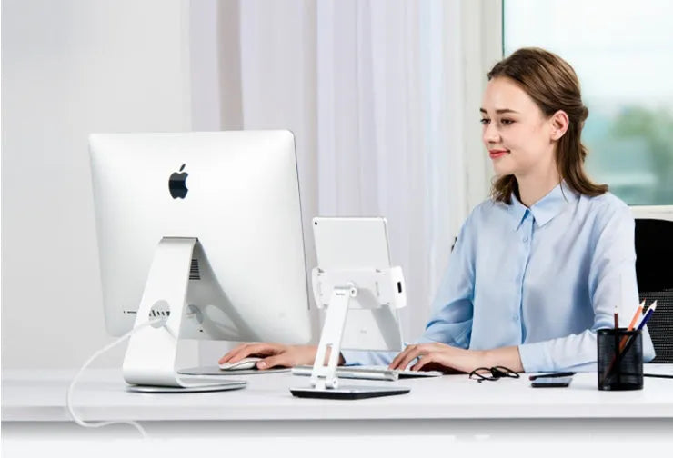 Folding aluminium phone and tablet stand in silver, shown holding a tablet at an angle.