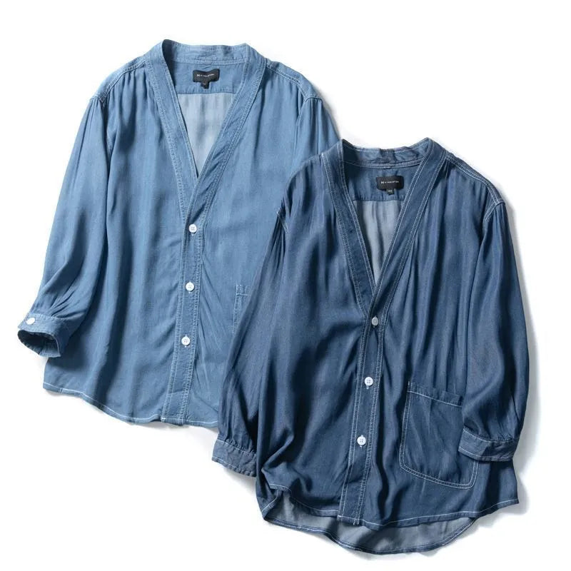 Men's dark blue denim coat with three-quarter sleeves and V-neck collar showing front pocket detail