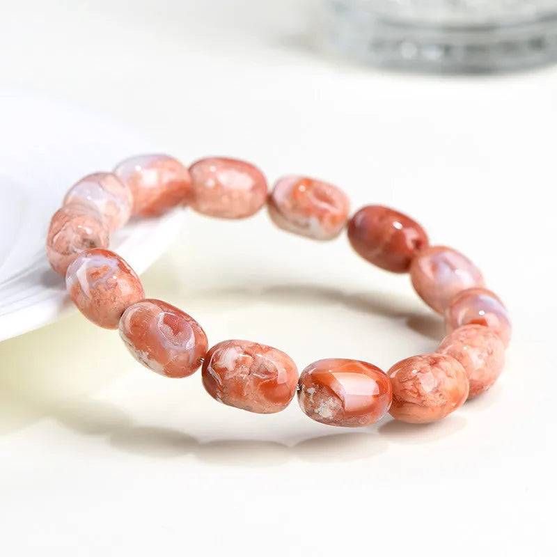 Natural cherry agate bracelet with 10x14mm barrel beads and Ruyi geometric elements