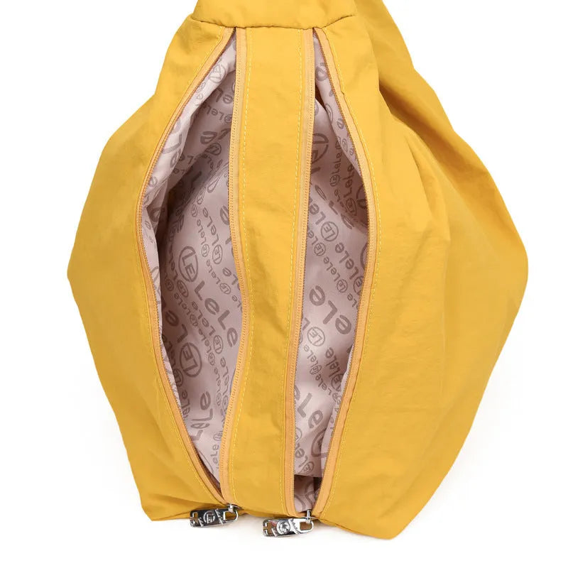 Soft nylon women's underarm bag in heart shape, shown in black, yellow, khaki, or blue.