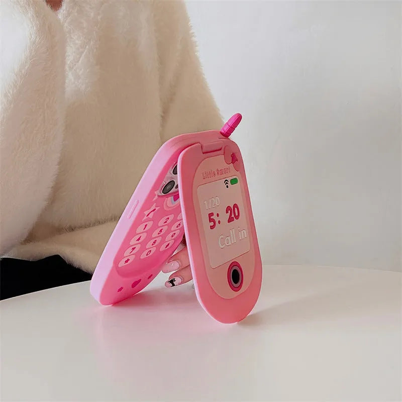 Pink silicone iPhone case with a flip-open mirror cover on a table.