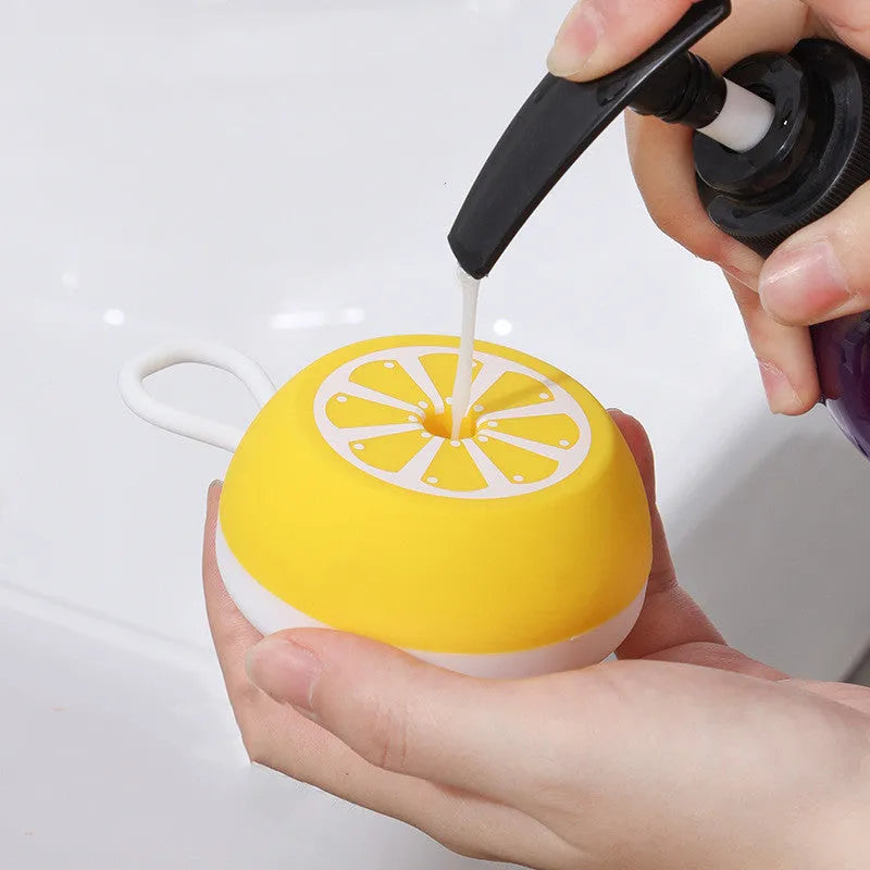 Yellow silicone pet bath brush with massage nodes and comb teeth for dogs and cats.