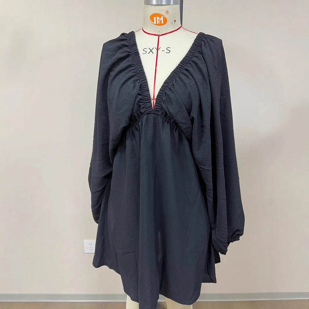 Women's apricot V-neck long-sleeve dress with puff sleeves and a flounce swing skirt on a hanger.