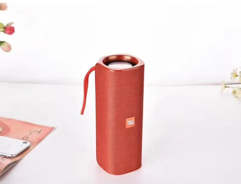 Wireless Bluetooth speaker with cloth cover in multiple colours showing front speaker grille and control buttons