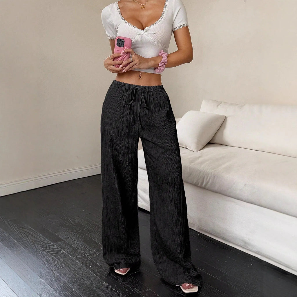 Women's black wide-leg trousers with lace-up waist detailing and mid-rise fit