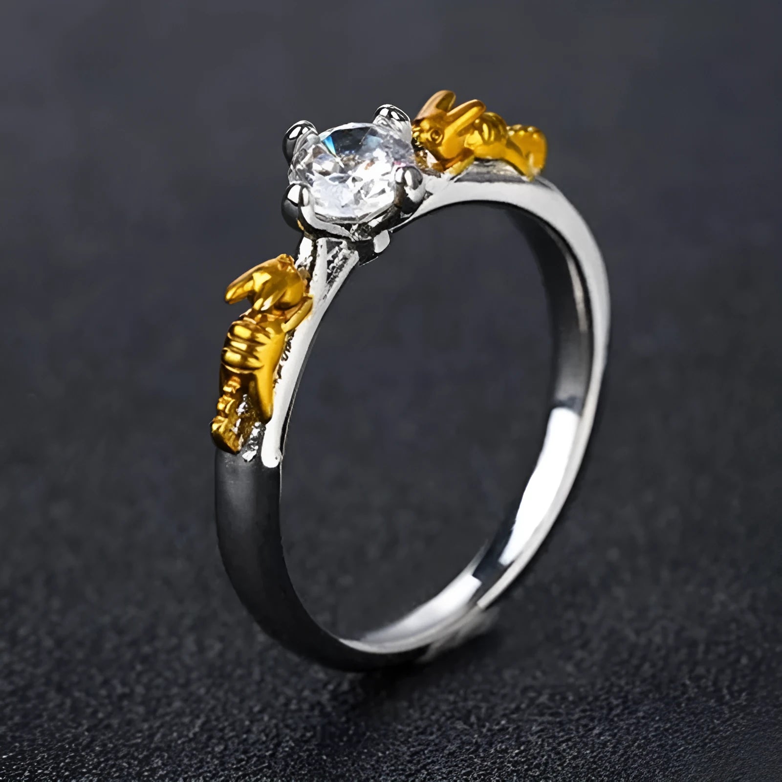 Copper crown design crystal ring in black gold finish on a size chart.