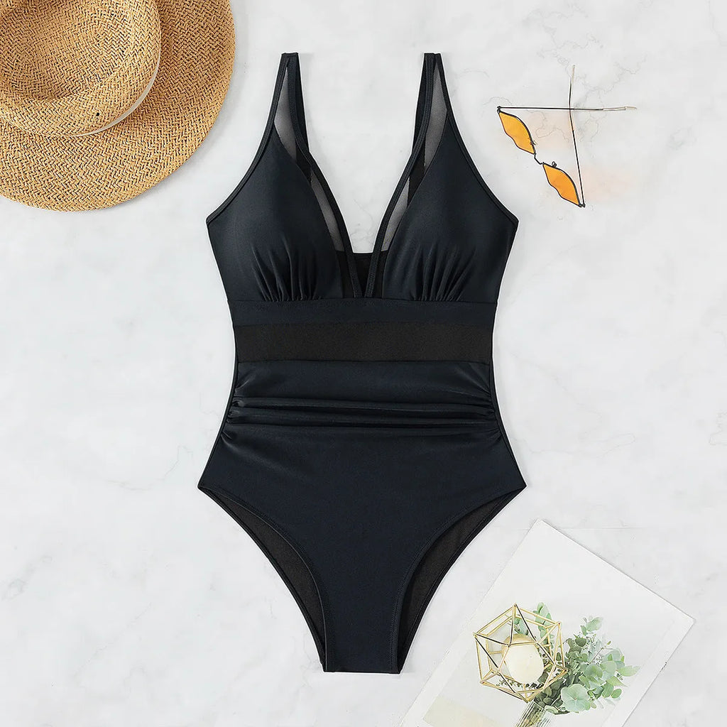 Black sleeveless one-piece swimsuit with halter neck for women.