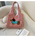 Soft canvas shoulder bag with red stripes and cartoon embroidery of a puppy wearing a red hat, square vertical shape, double shoulder straps