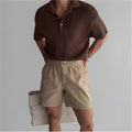 Cotton sports shorts in loose fit design shown in black, white and khaki colours