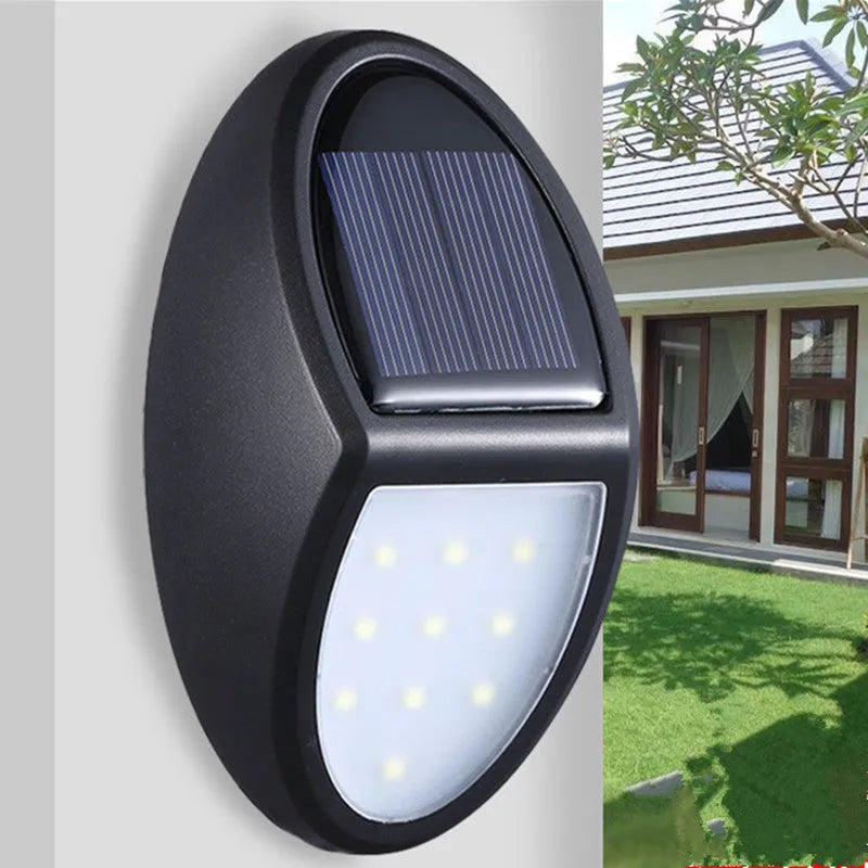 Black solar-powered LED wall light with automatic sensor for outdoor garden or patio illumination