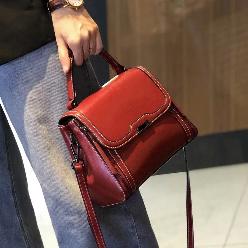 Women's brown genuine leather messenger bag with shoulder strap and internal pockets