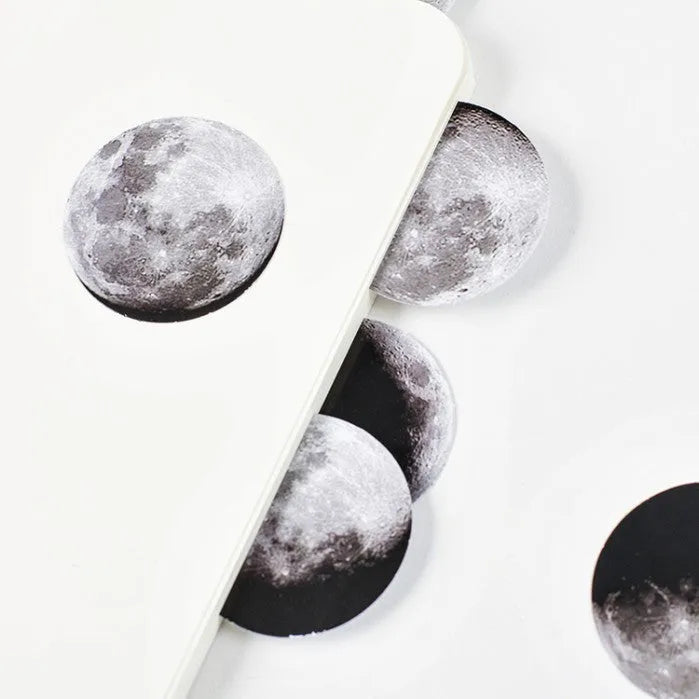 Black moon phase, planet, and calendar design stickers on a sheet, 45 pieces total.
