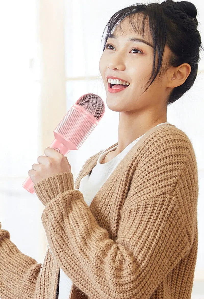 Wireless Bluetooth karaoke microphone in pink, blue, or mint green with built-in speaker.